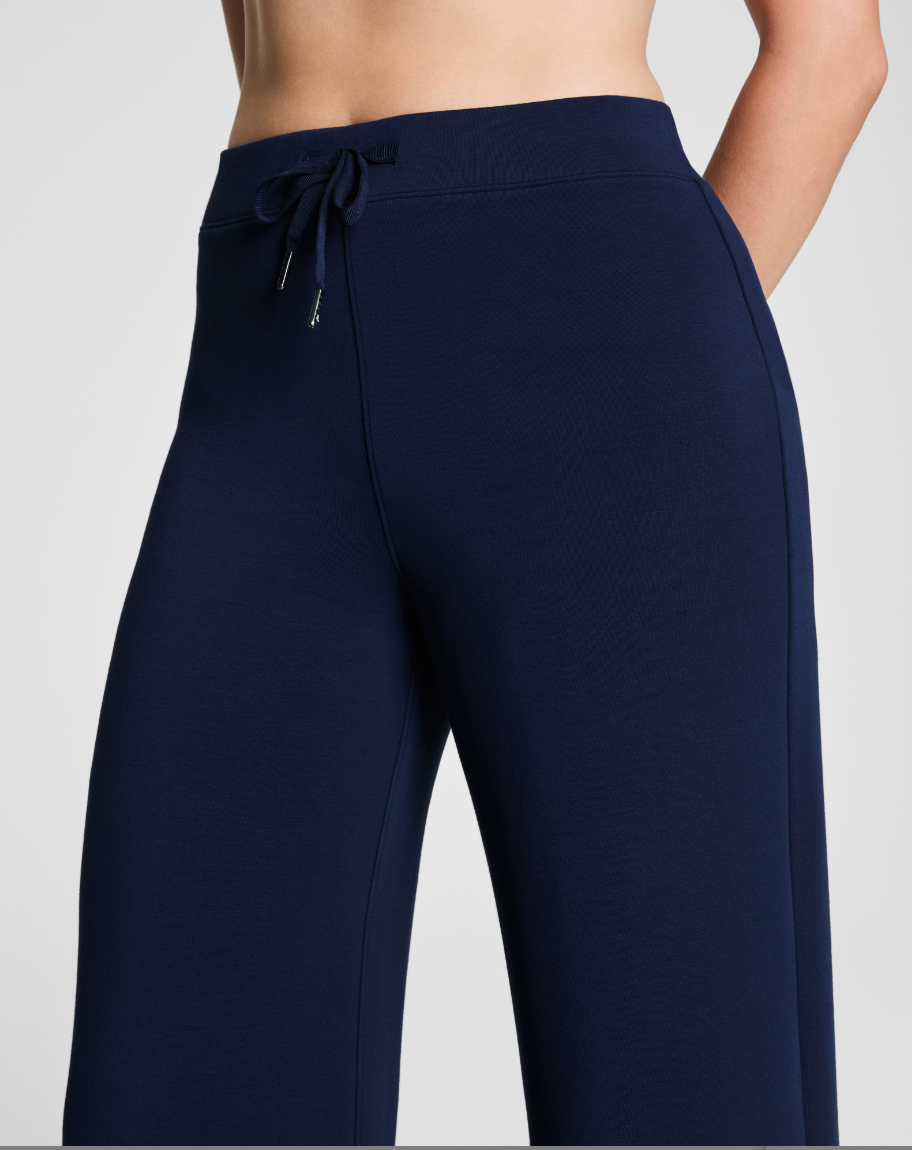 Navy blue pants with a drawstring on a light gray background