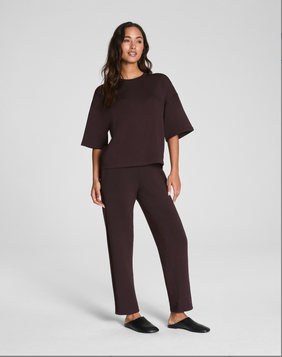 Woman wearing a brown outfit on a white background