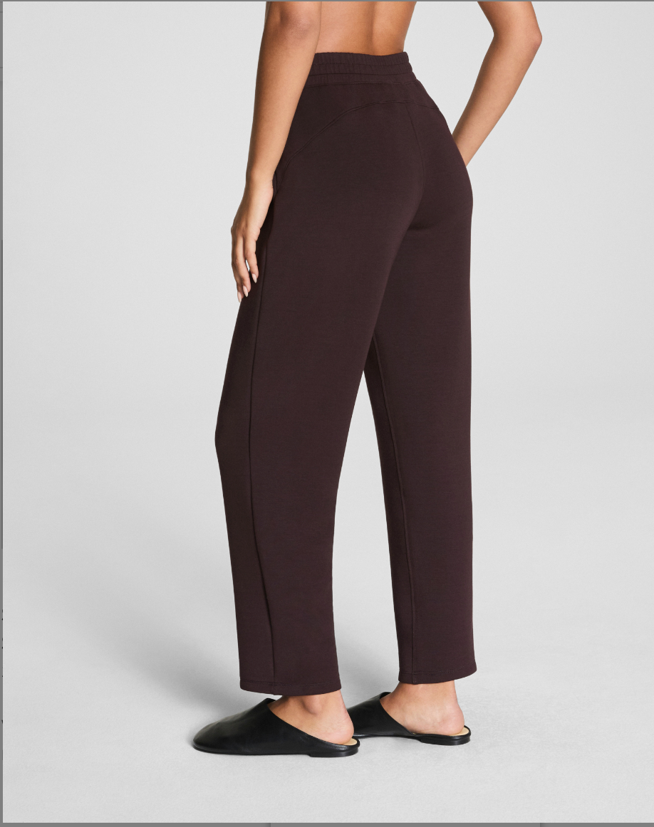 Brown pants worn by a person on a light gray background