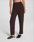 Dark brown pants worn by a person on a light gray background