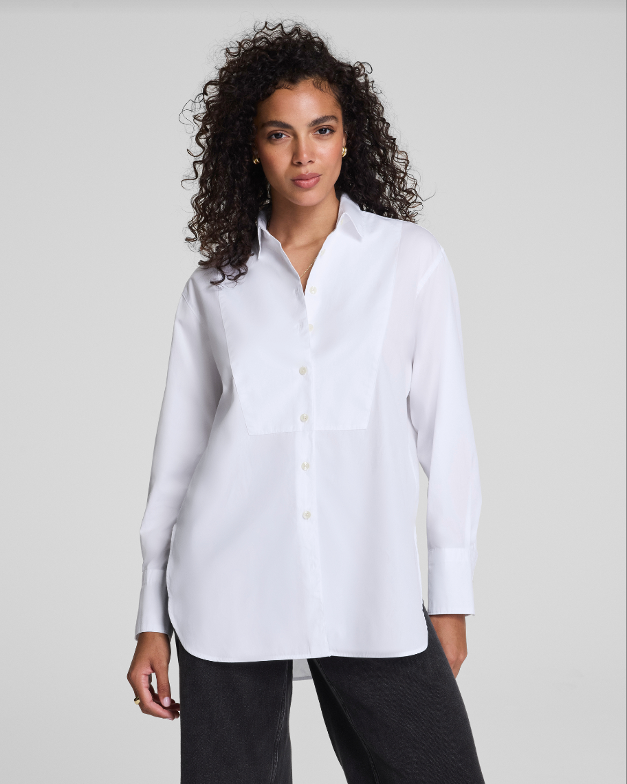 Woman wearing a white shirt against a plain background