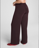 Brown wide-leg pants worn by a person on a light gray background