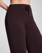 Dark brown pants with a drawstring on a light gray background