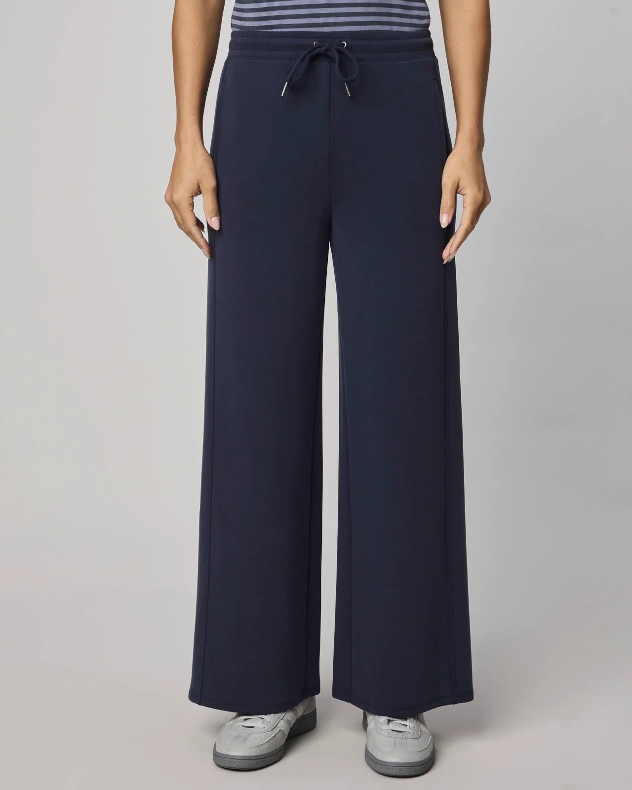 Navy wide-leg pants worn by a person on a plain background