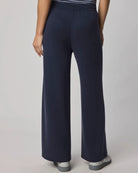 Navy blue wide-leg pants worn by a person on a plain background