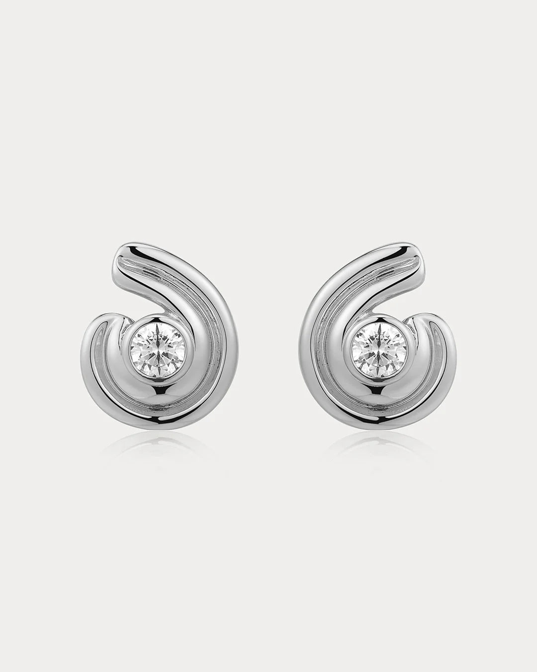 Pair of silver earrings with diamond-like centers on a white background